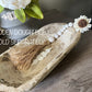 WOODEN BEADED WHITEWASHED TASSEL WITH WOODEN FLOWER EMBELLISHMENT