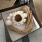 WOODEN BEADED WHITEWASHED TASSEL WITH WOODEN FLOWER EMBELLISHMENT